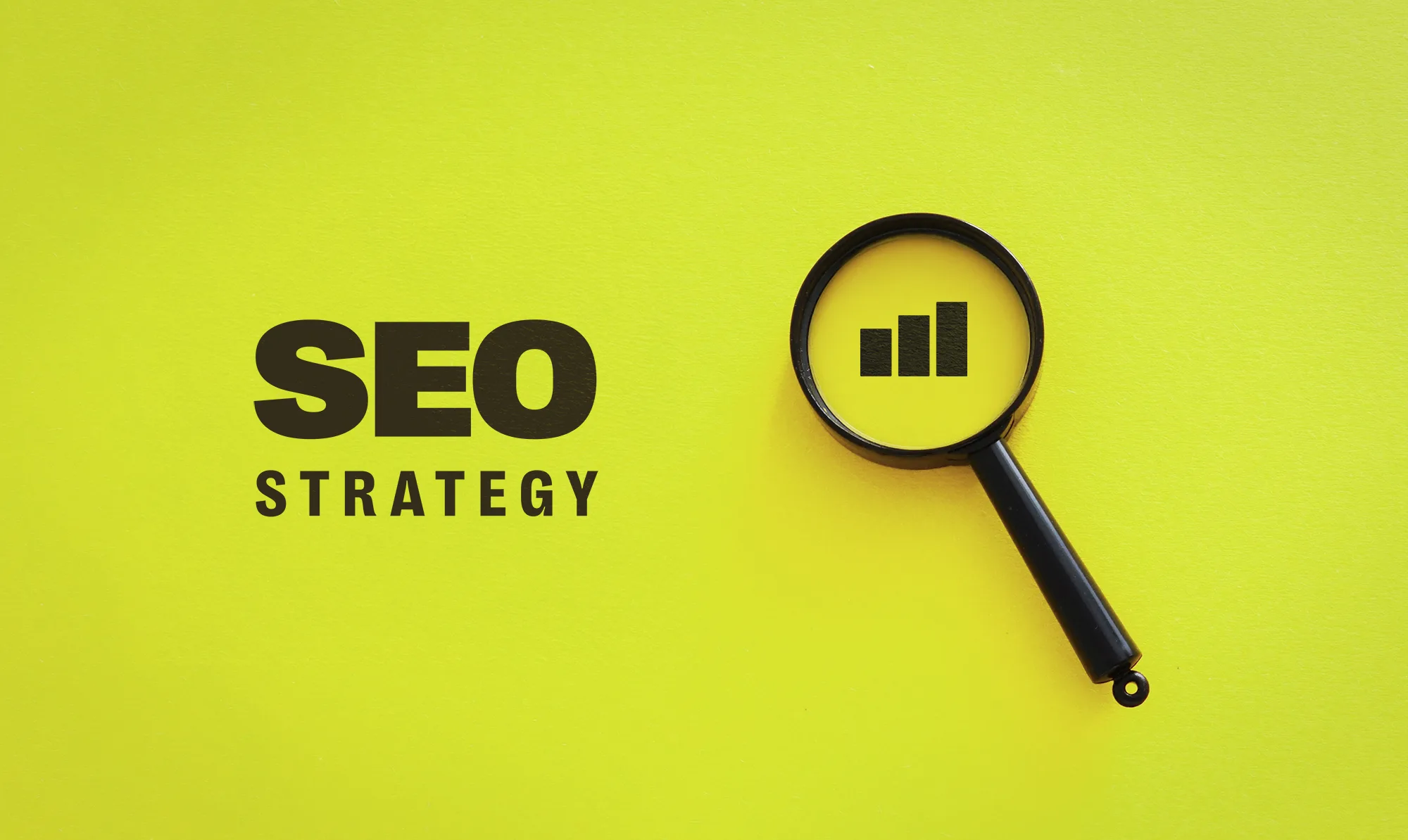 Magnifying glass highlighting a growth chart next to the words “SEO Strategy” on a bright yellow background, representing search engine optimization and digital growth planning