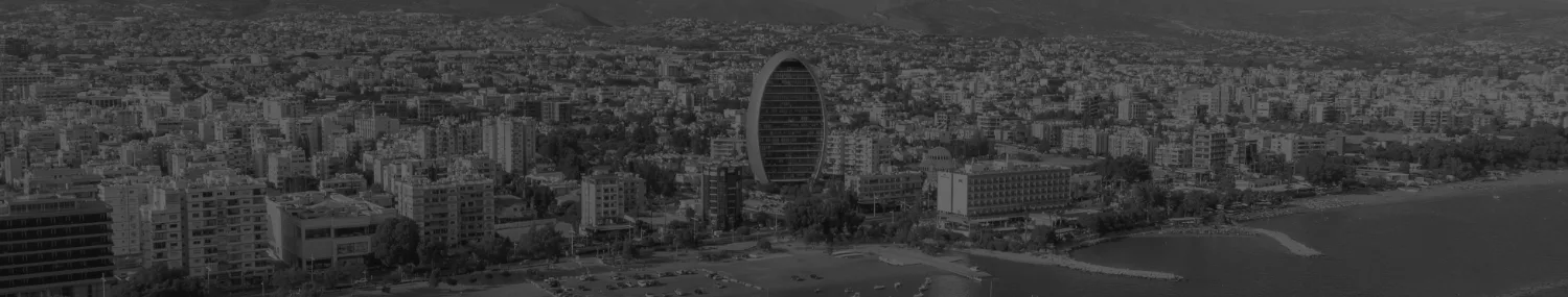 Dark-toned cityscape banner featuring a modern oval-shaped skyscraper surrounded by an urban skyline, designed for a website landing page