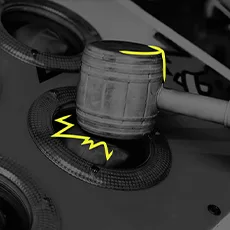 Close-up illustration of a metallic hammer striking a circular surface with glowing yellow accents, symbolizing the impact and effectiveness of pop-under advertising