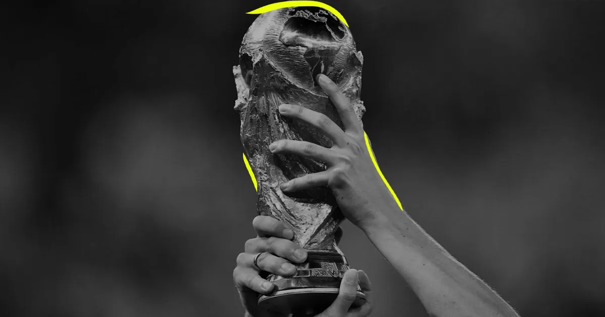 black and white image of someone lifting the FIFA World Cup trophy
