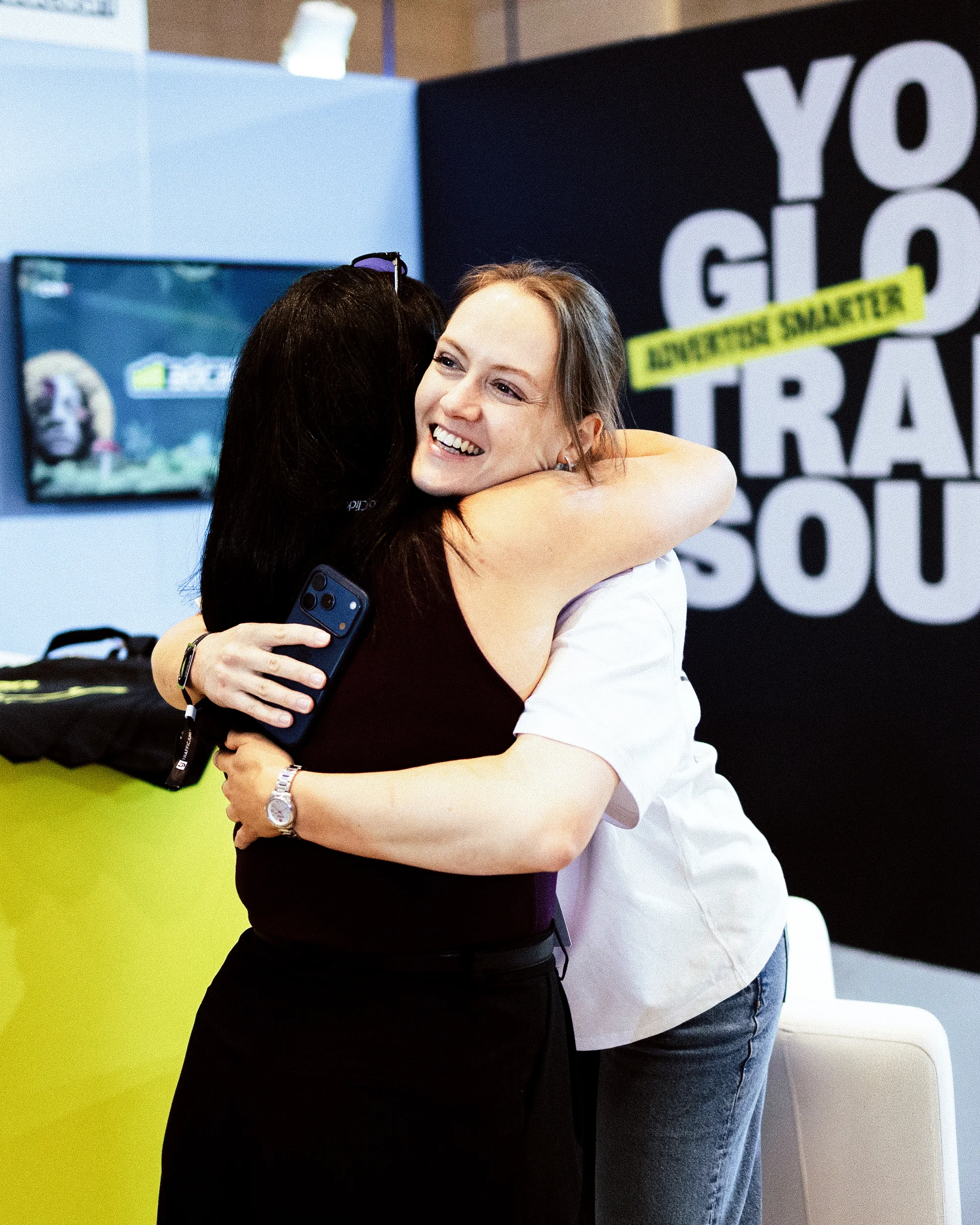 Julia hugging a partner at the Adcash booth