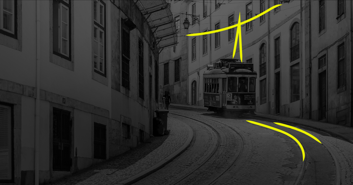 Black and White photo of a tram rolling down a Lisbon street