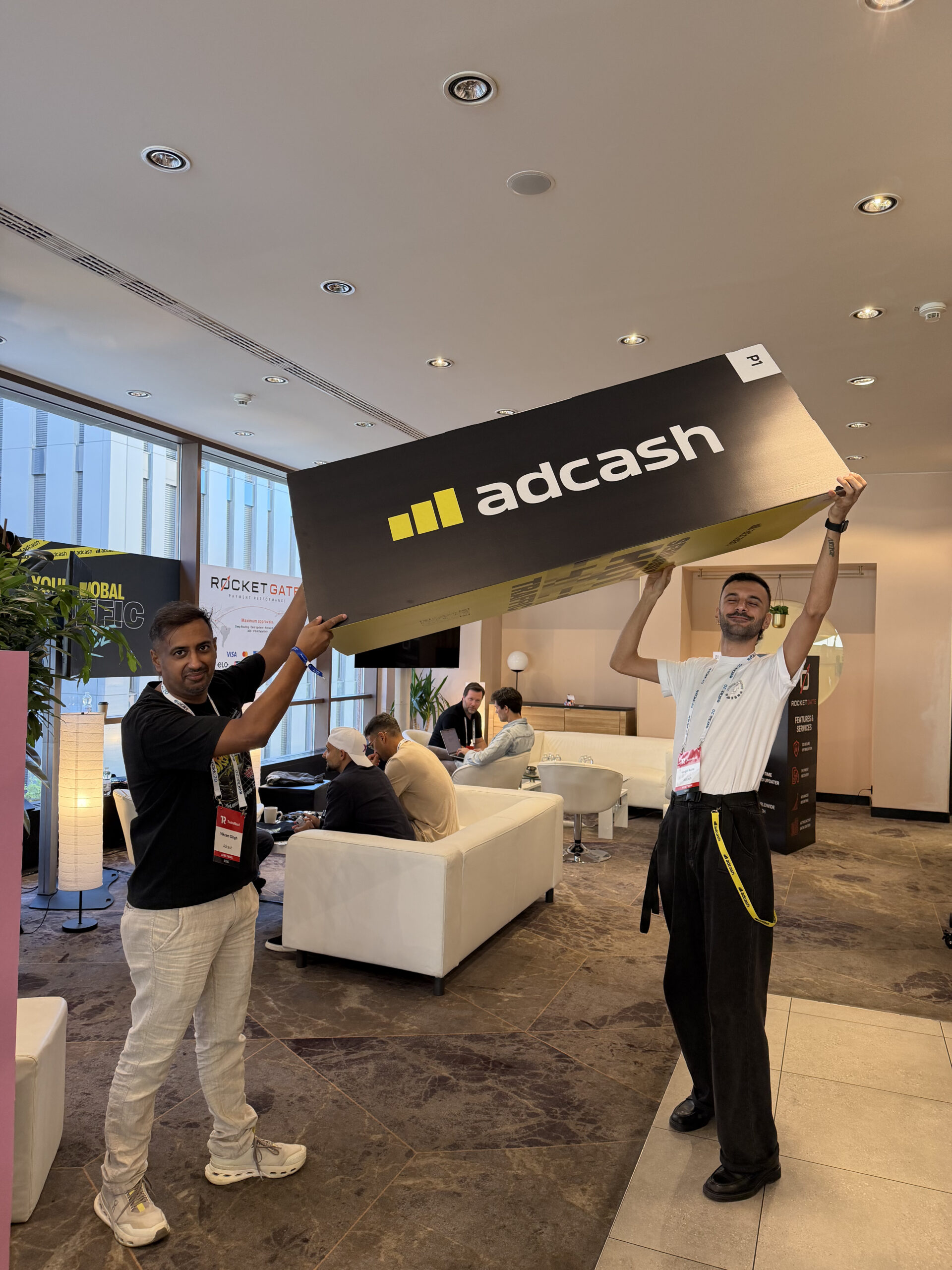 An Adcash sign being held up high at TES Prague 2026
